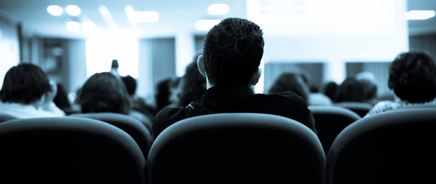 conference attendees from behind